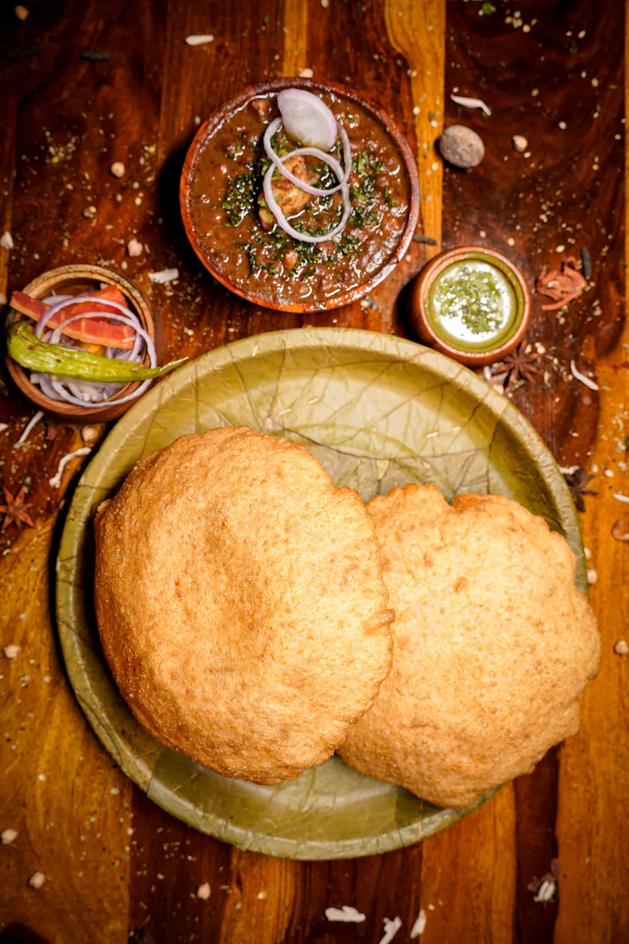 Chole bhature served on a leaf plate