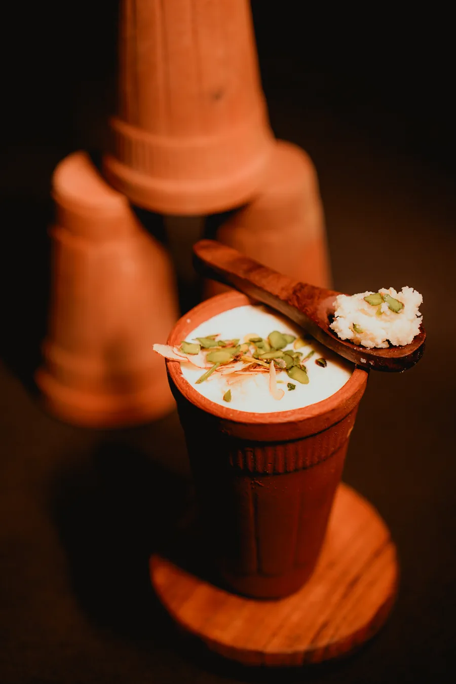 Lassi with a wooden spoon resting on the matka